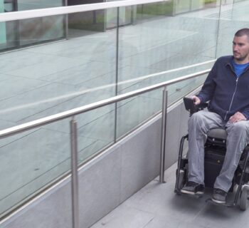 Shutterstock photo included of a powered wheelchair user