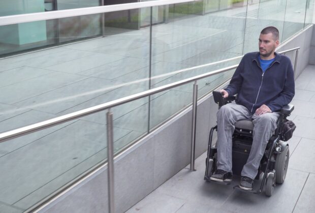 Shutterstock photo included of a powered wheelchair user